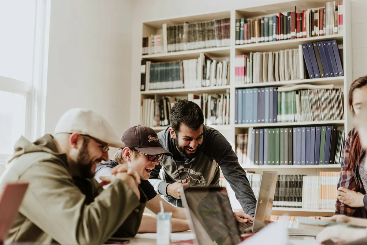 Students working together at a table in a university library